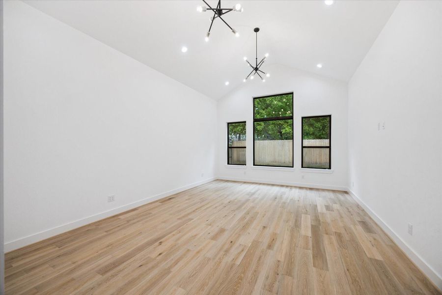 Vaulted ceilings, oversized windows, and modern chandeliers elevate the spacious primary suite, filling it with natural light and architectural interest. A serene retreat that blends bold design with everyday comfort. Vaulted ceilings, oversized windows, and modern chandeliers elevate the spacious primary suite, filling it with natural light and architectural interest. A serene retreat that blends bold design with everyday comfort.