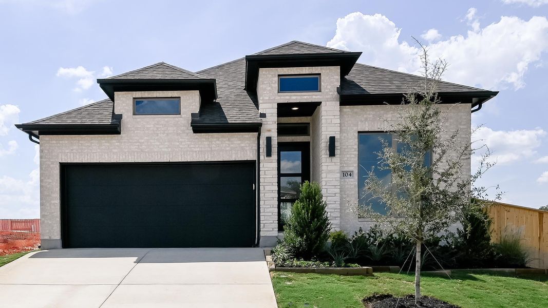 View of front of house featuring stone siding, driveway, and a shingled roof View of front of house featuring stone siding, driveway, and a shingled roof