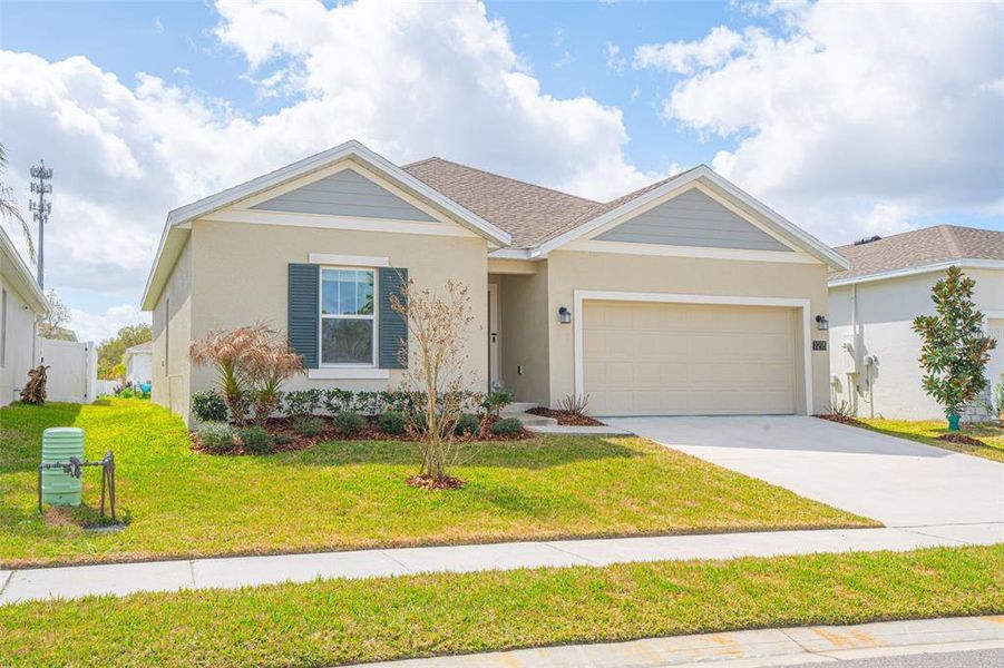 Front exterior of a new home in Vineland Reserve, Osteen, FL, highlighting curb appeal (Image 24).