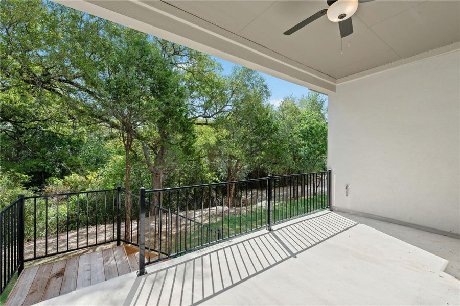 Balcony featuring a ceiling fan and view of scattered trees Balcony featuring a ceiling fan and view of scattered trees
