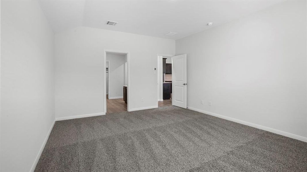 Room with neutral wall paint and gray carpet flooring Room with neutral wall paint and gray carpet flooring