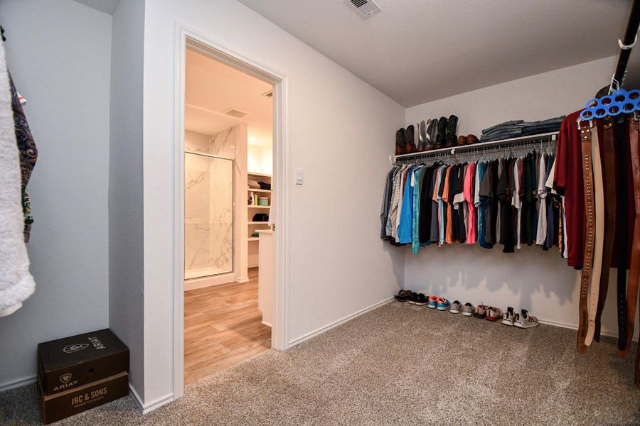 Spacious walk-in closet with ample hanging space and shelving.