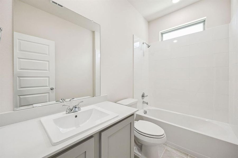 Bathroom in the Claret home plan by Trophy Signature Homes  REPRESENTATIVE PHOTO