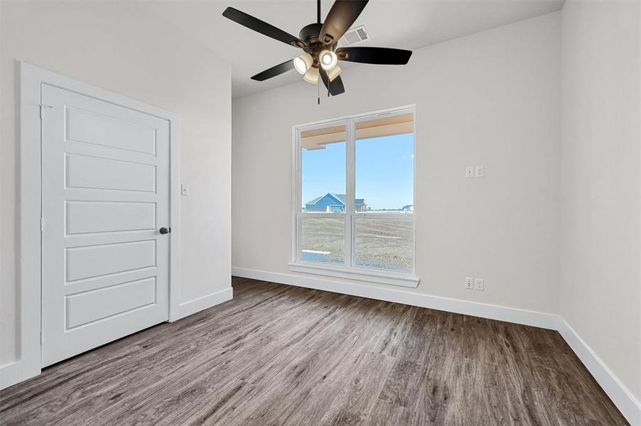 Unfurnished room featuring ceiling fan and hardwood / wood-style floors