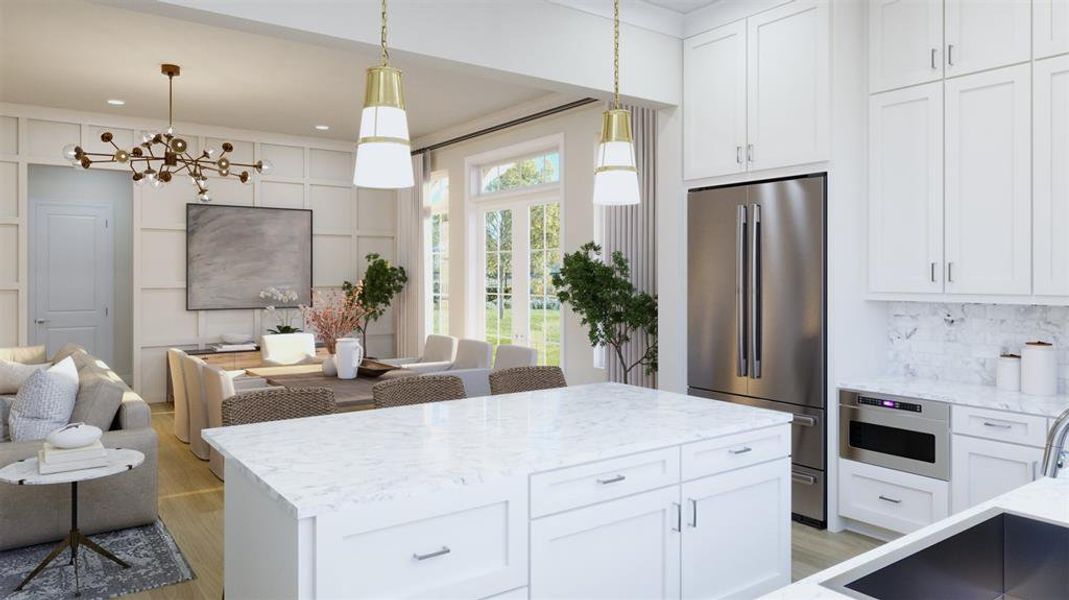 Kitchen with appliances with stainless steel finishes, light stone counters, and white cabinetry