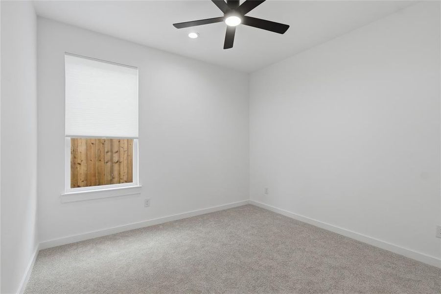 Carpeted empty room with ceiling fan and recessed lighting Carpeted empty room with ceiling fan and recessed lighting