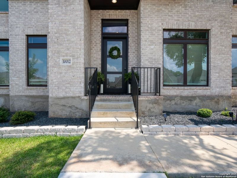 Front exterior of a new home in Balcones Creek 70', Boerne, TX, highlighting curb appeal (Image 21). Front exterior of a new home in Balcones Creek 70', Boerne, TX, highlighting curb appeal (Image 21).