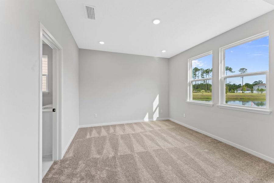 Miramar Floorplan Lot 81 Primary Bedroom with Large Windows at Concourse Crossing in Fernandina Beach