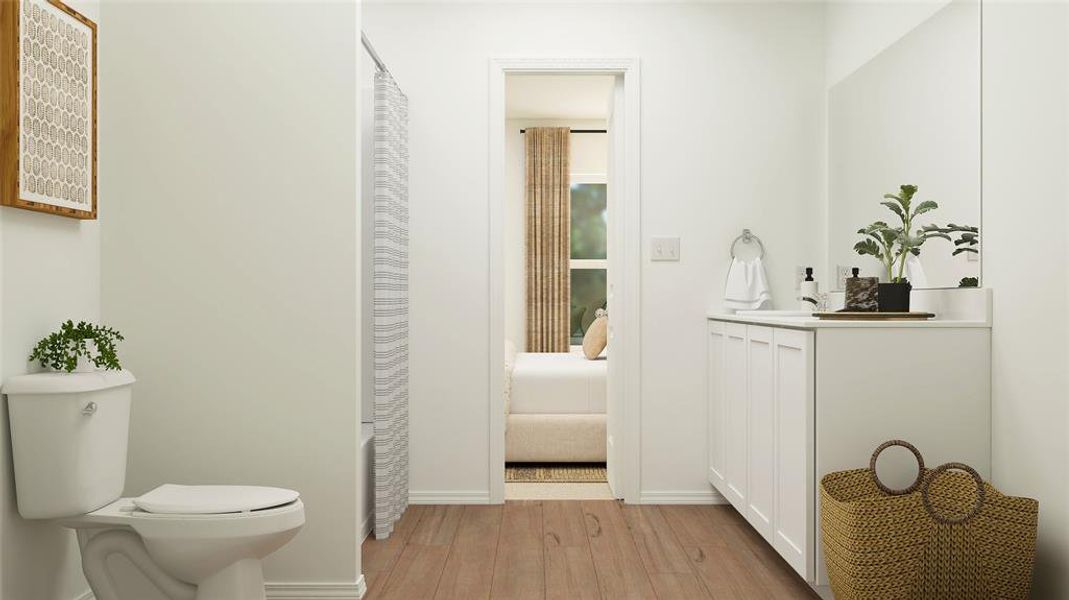 Bathroom with curtained shower, wood-type flooring, toilet, and vanity