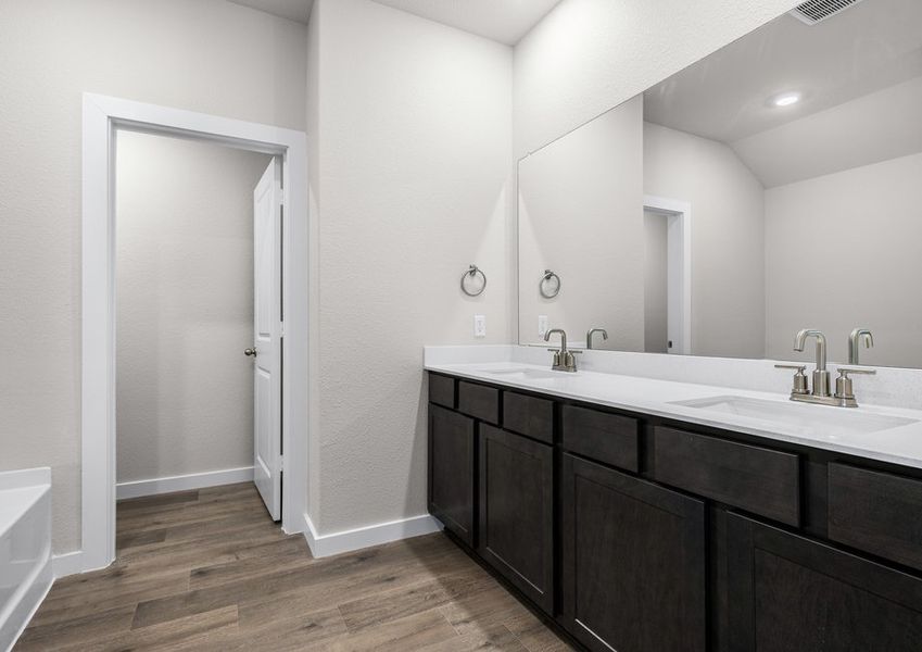 The master bathroom has a sprawling dual-sink vanity.