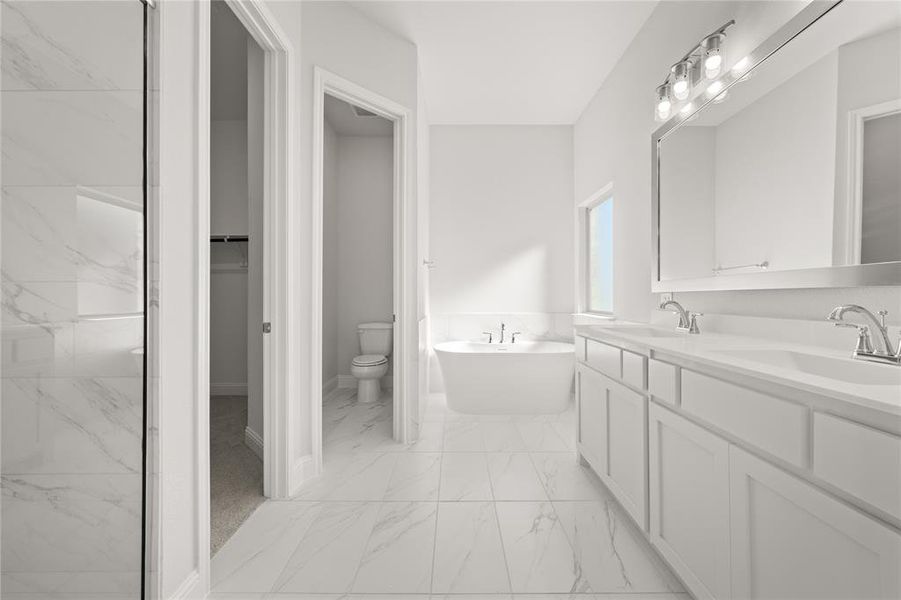 Bathroom with a bathing tub, vanity, and toilet