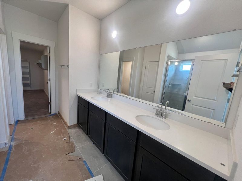 Bathroom with a stall shower, double vanity, and a walk in closet Bathroom with a stall shower, double vanity, and a walk in closet