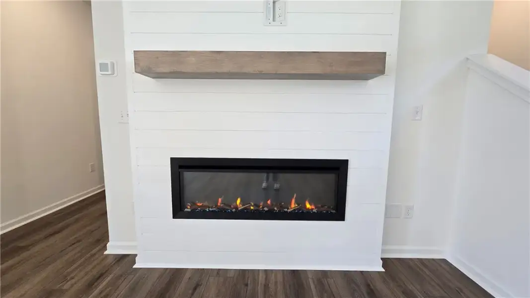 A modern electric fireplace with a floating wooden
