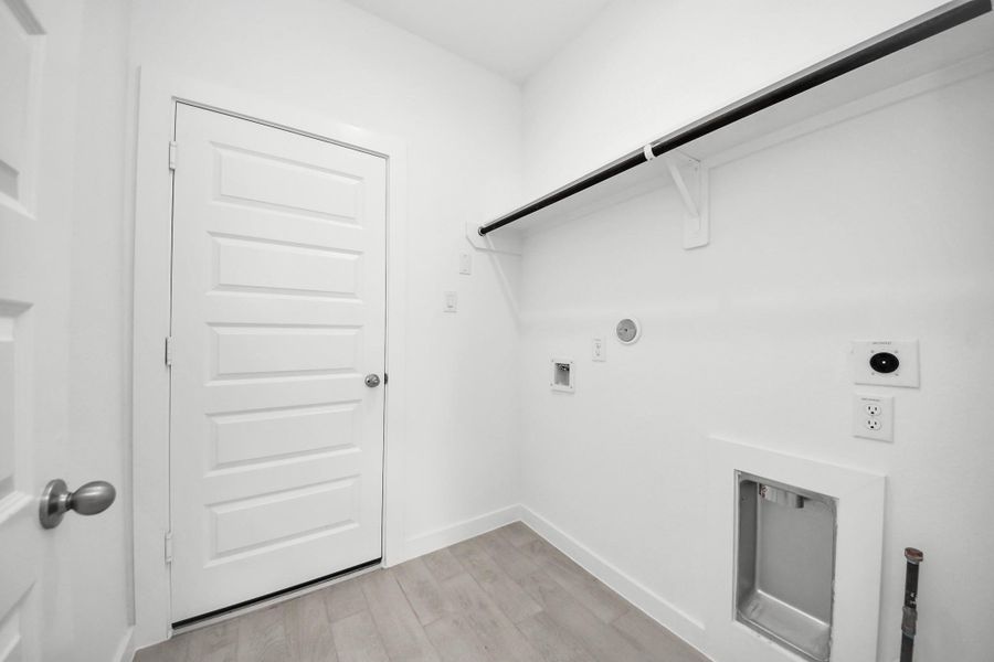 A perfect blend of functionality and comfort. Capture the essence of easy living with a first-floor laundry room, thoughtfully equipped with shelving for effortless organization. Both electric and gas connections available. Sample photo of completed home with similar floor plan. Actual colors and selections may vary. A perfect blend of functionality and comfort. Capture the essence of easy living with a first-floor laundry room, thoughtfully equipped with shelving for effortless organization. Both electric and gas connections available. Sample photo of completed home with similar floor plan. Actual colors and selections may vary.