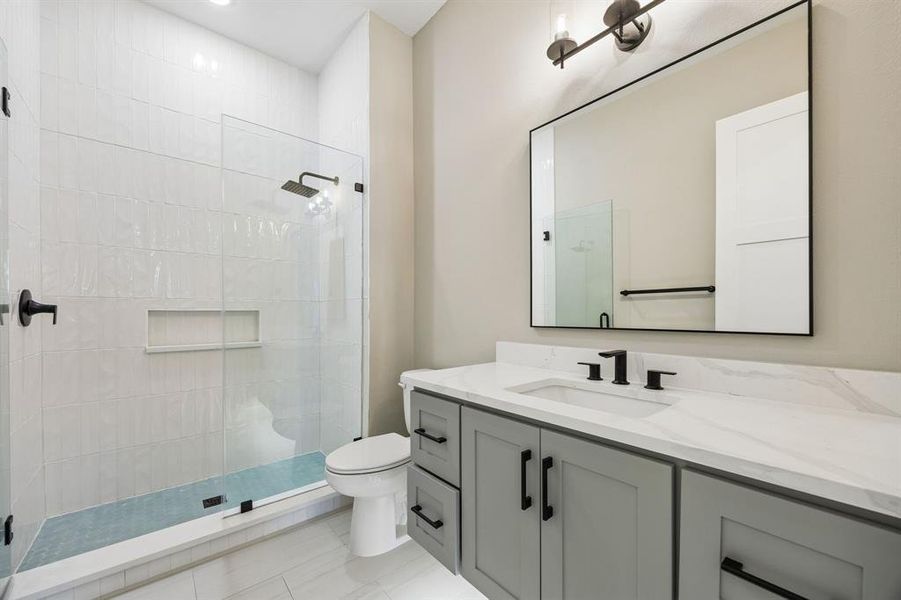Bathroom featuring vanity, tiled shower, and recessed lighting Bathroom featuring vanity, tiled shower, and recessed lighting