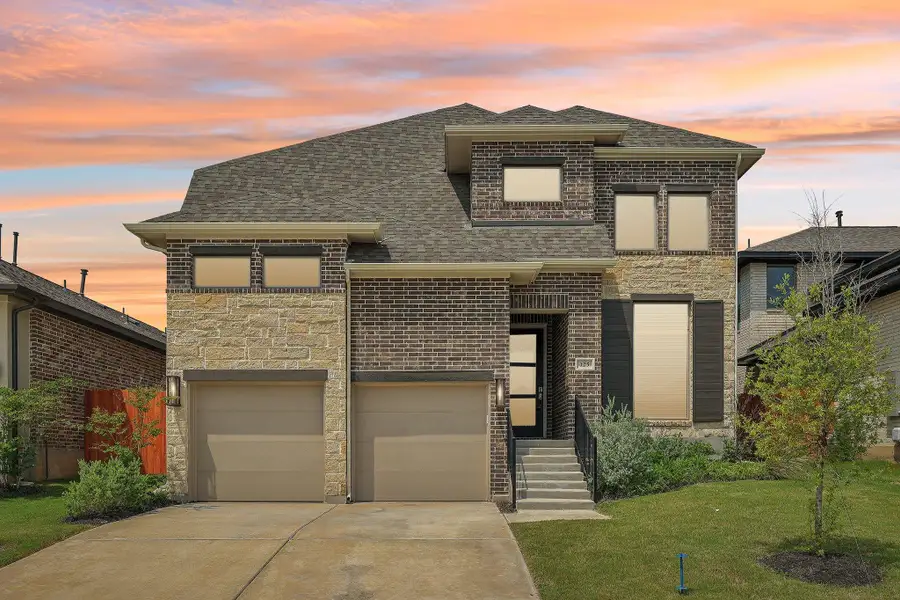 View of front of house with brick siding, driveway, roof with shingles, a garage, and a front lawn View of front of house with brick siding, driveway, roof with shingles, a garage, and a front lawn