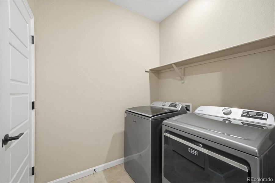 Upper level laundry room with an extra linen closet and has been stubbed for a utility sink.  Washer and dryer are staying with the property.