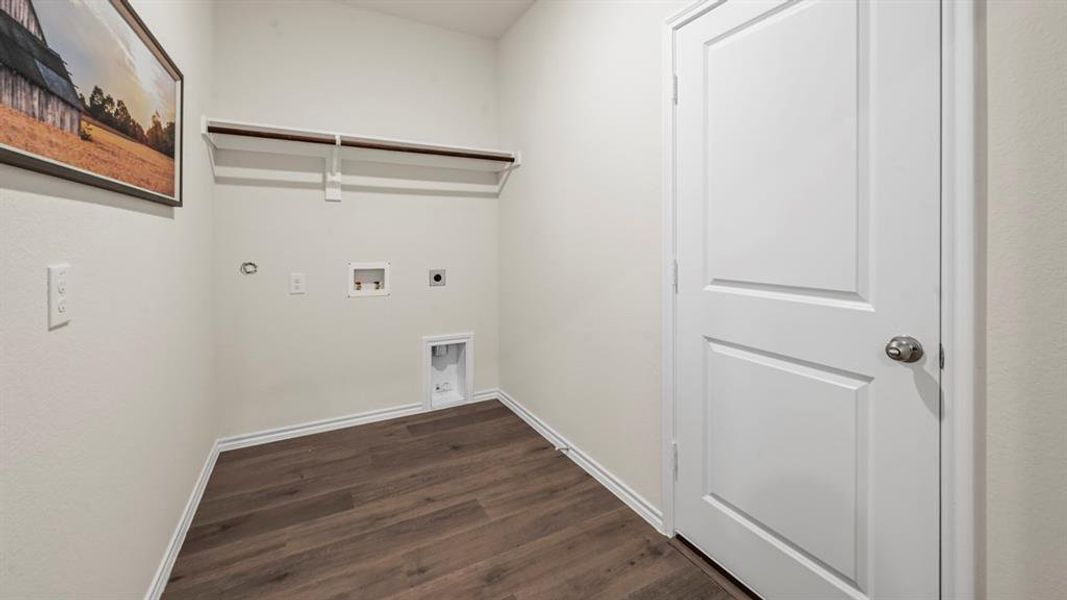 Laundry room featuring hookup for an electric dryer, dark wood finished floors, washer hookup, and hookup for a gas dryer