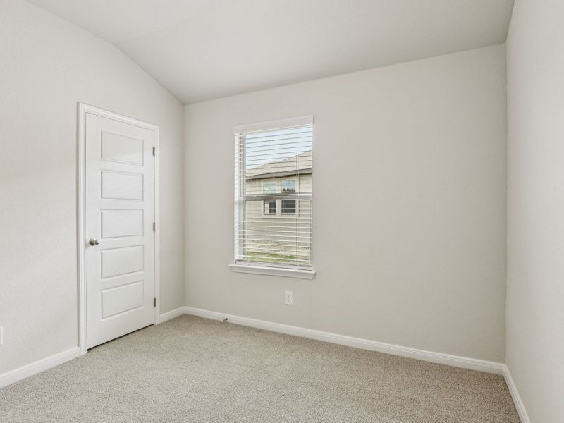 Guest bedroom in the Oleander floorplan at a Meritage Homes community.