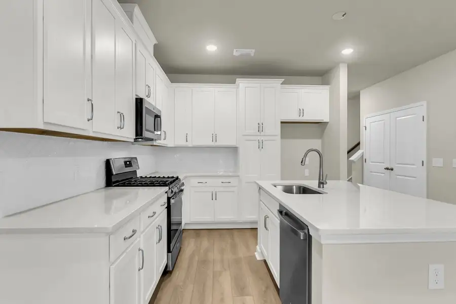 Stunning quartz countertops and a herringbone backsplash steal the show.