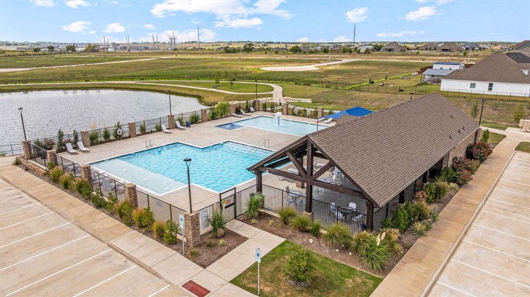 Bird's eye view of a pool area and a nearby body of water