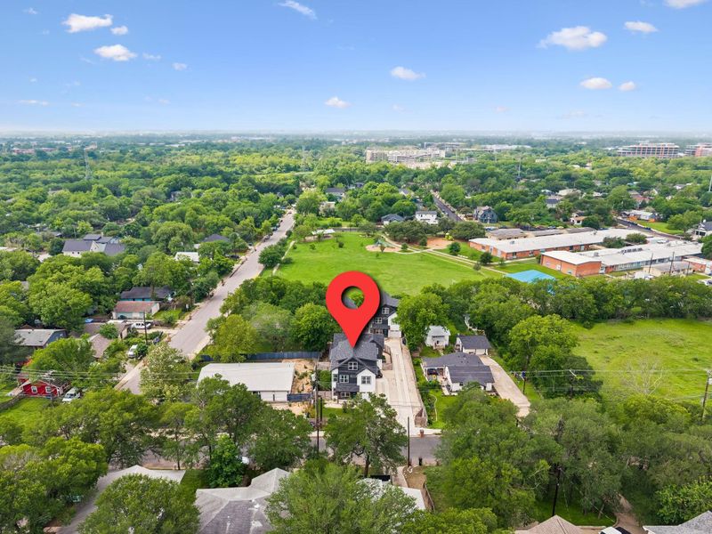 Aerial perspective showcasing the property's location within a verdant neighborhood