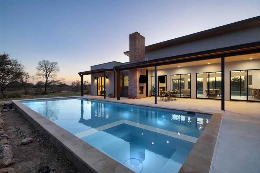 View of swimming pool with a patio area and a pool with connected hot tub