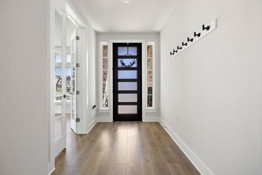 Wide entry way, french doors lead to the office/study