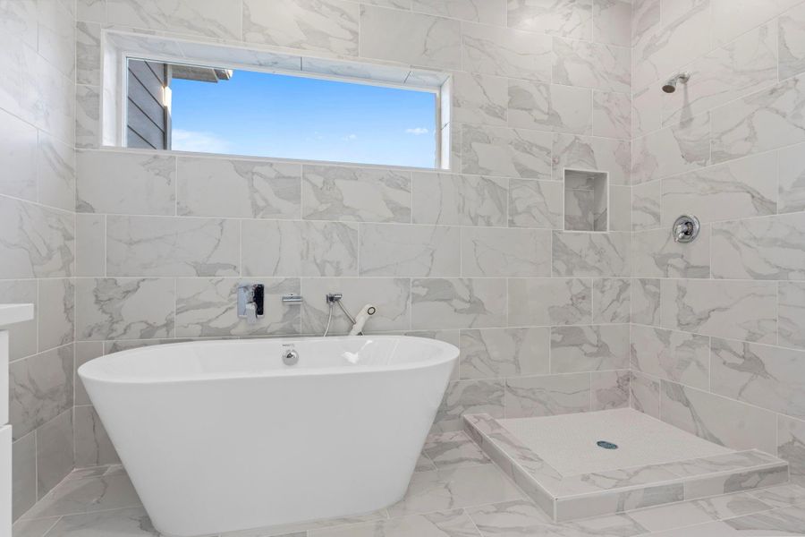 Elegant bathroom offering the best of both worlds — a tub and separate shower.