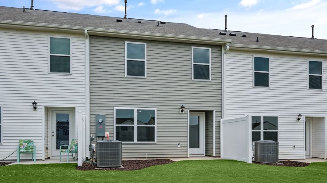 Exterior details and patio area of a home in The Townes at Hunter Hill, Rocky Mount (Image 26).