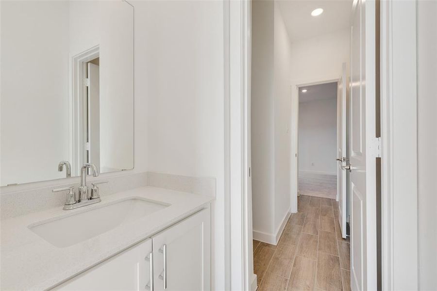 Bathroom with hardwood / wood-style floors and vanity