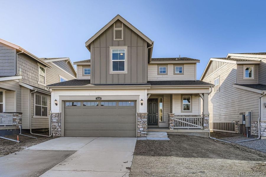 Front exterior of a new home in Vermilion Creek: The Pioneer Collection, Centennial, CO, highlighting curb appeal (Image 1).