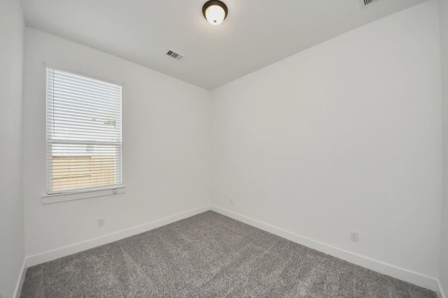 Representative unfurnished interior of a home built from the Bonneville by Chesmar Homes in Meridiana 50's, Manvel (Image 37).