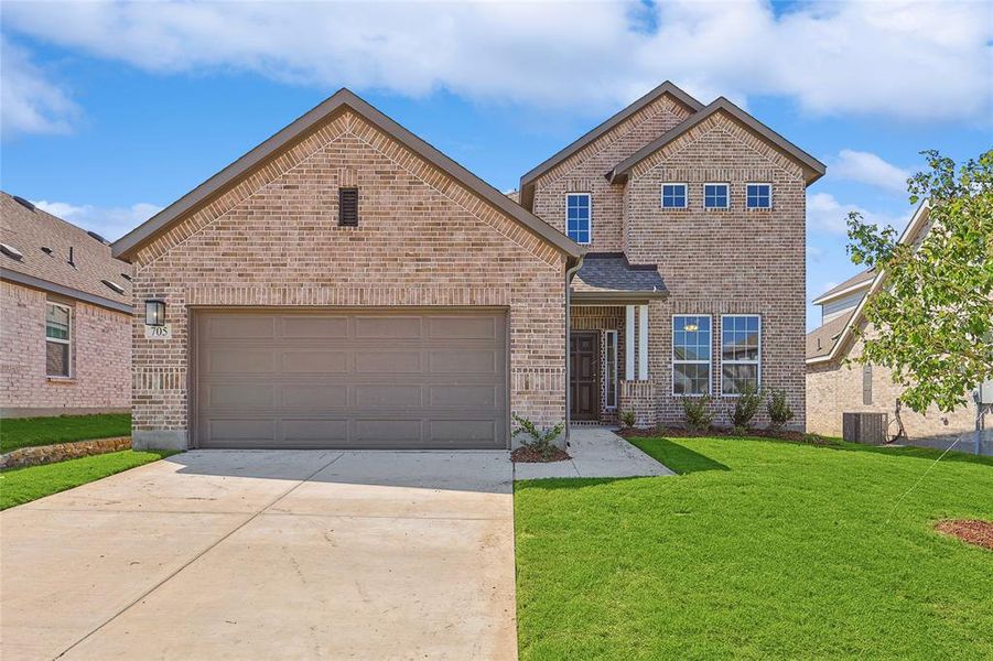 Front of property featuring a garage, central AC, and a front lawn