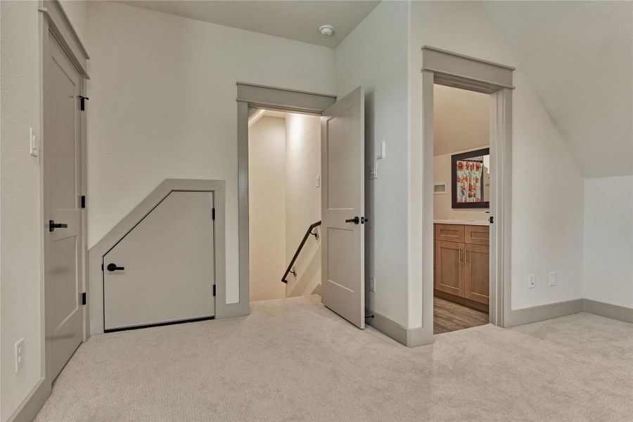 View of the full bathroom and closet upstairs in the game room or 5th bedroom