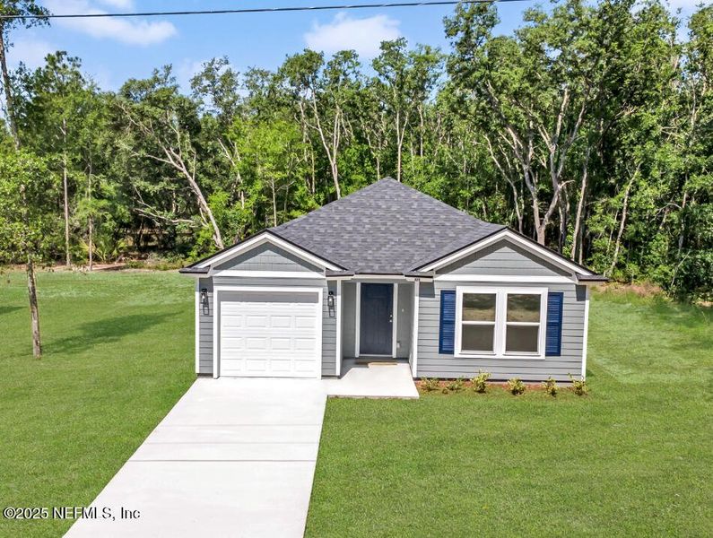 Front exterior of a new home in , Satsuma, FL, highlighting curb appeal (Image 1).