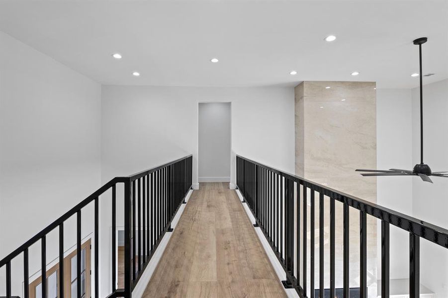Corridor with wood finished floors, baseboards, and recessed lighting Corridor with wood finished floors, baseboards, and recessed lighting