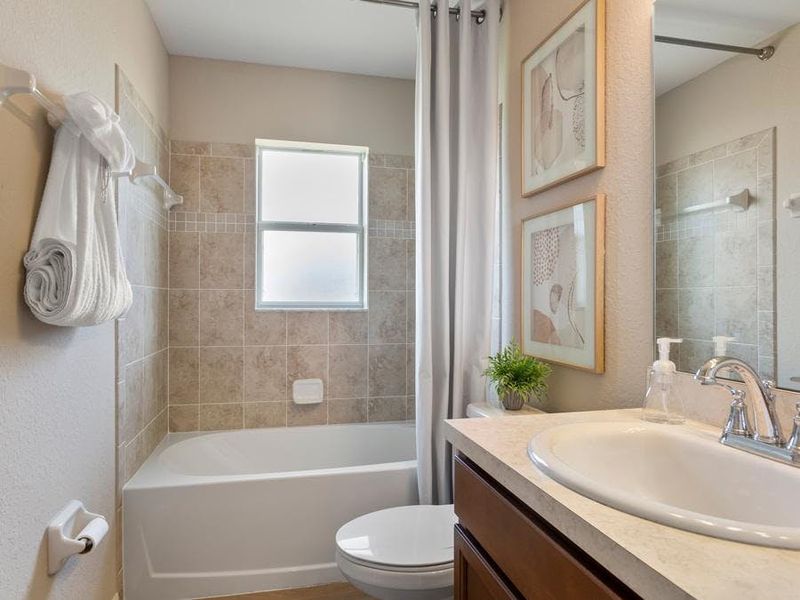 A hall bath serves the secondary bedrooms and guests.