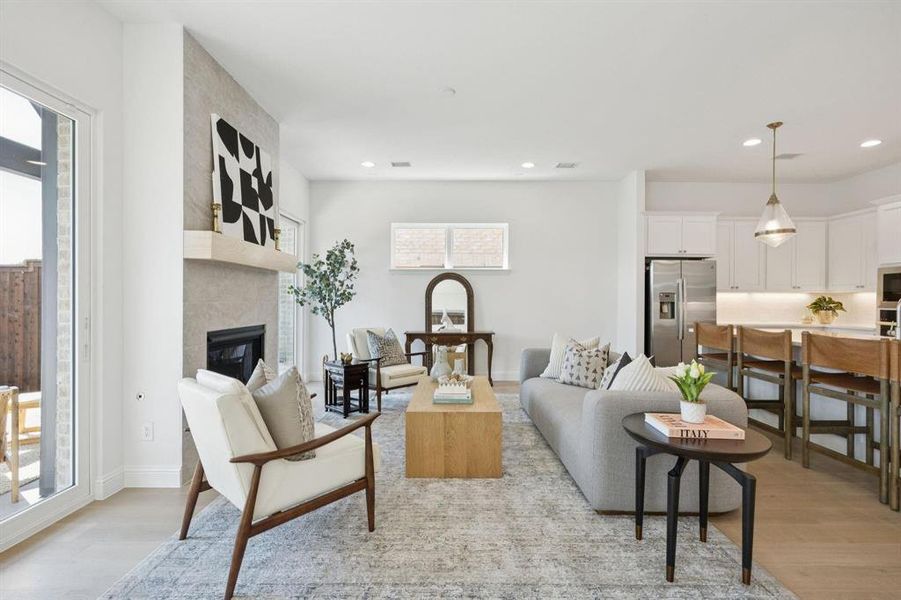Open-concept living area with wood-finish flooring and recessed lighting