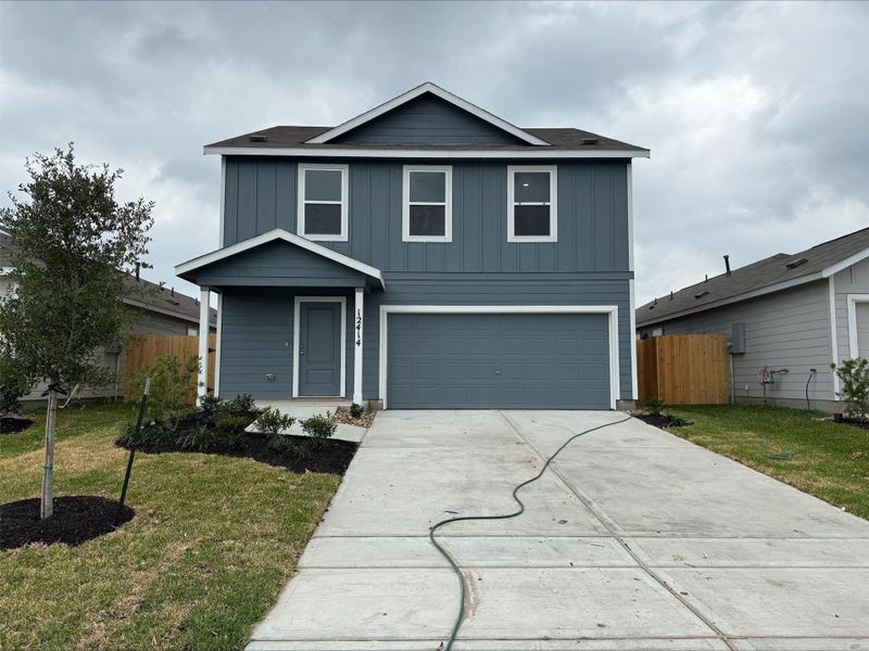Front exterior of a new home in Spring Branch Crossing, Conroe, TX, highlighting curb appeal (Image 2).