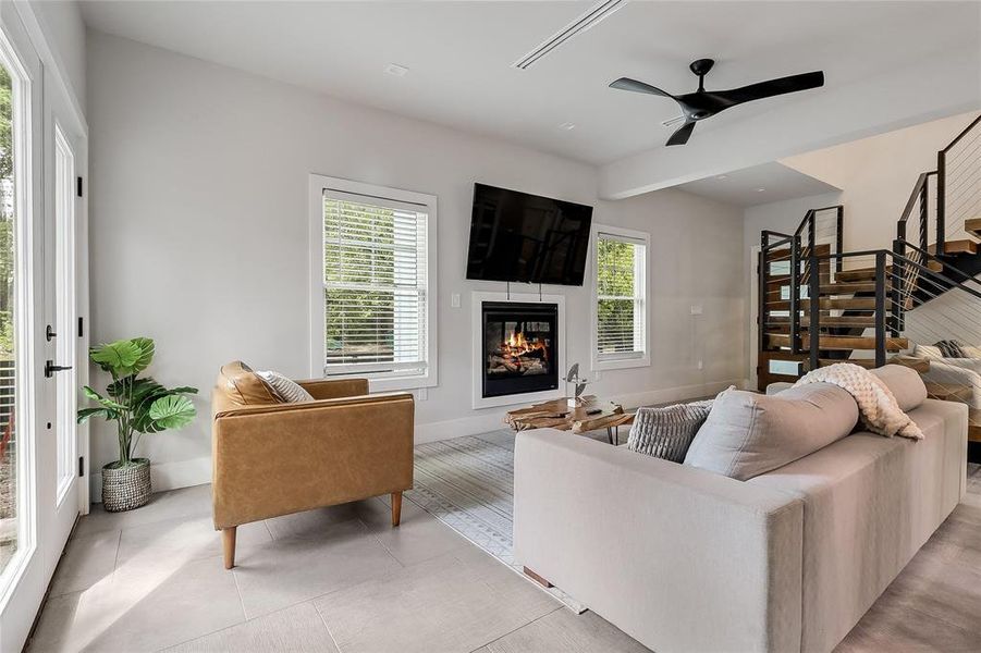 A striking fireplace forms a focal point in this inviting living space with sleek flooring.
