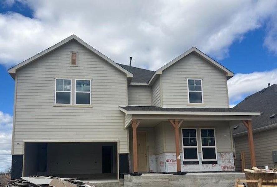 View of front facade with a garage and covered porch