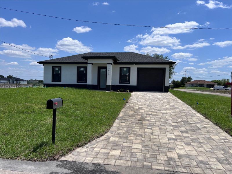 Front exterior of a new home in , Lehigh Acres, FL, highlighting curb appeal (Image 1). Front exterior of a new home in , Lehigh Acres, FL, highlighting curb appeal (Image 1).
