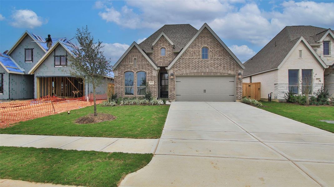 Front exterior of a new home in Everly 45', Tomball, TX, highlighting curb appeal (Image 2).