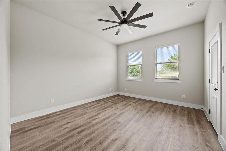 Unfurnished bedroom featuring light wood-style flooring and ceiling fan Unfurnished bedroom featuring light wood-style flooring and ceiling fan