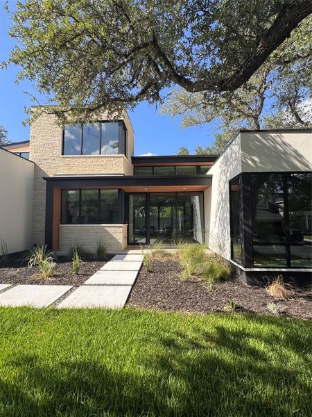 Modern architecture blends seamlessly with natural landscaping for striking curb appeal.