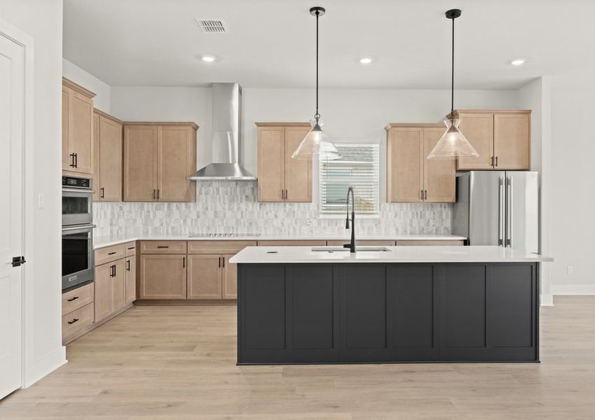 The kitchen has beautiful designer wood cabinetry.