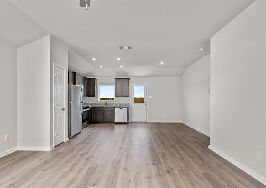 The kitchen, dining room and living room sit adjacent to one another.