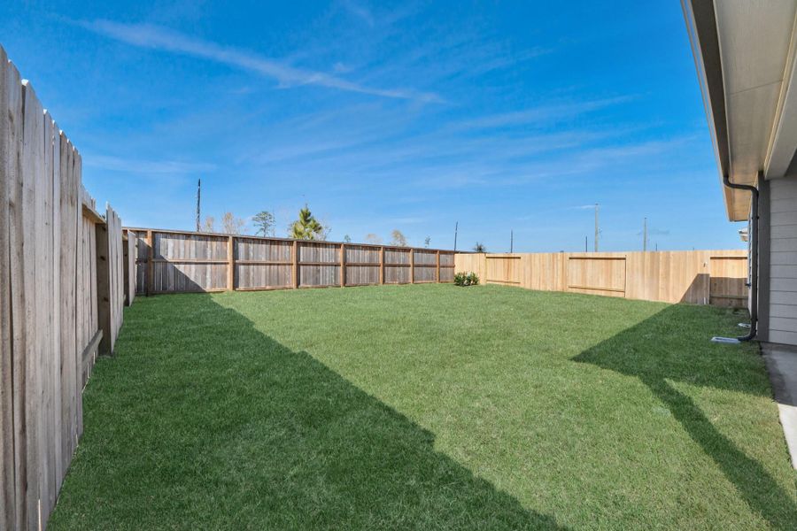 Backyard retreat, offering an abundance of space for kids to play and explore. The possibilities are endless in this outdoor haven, where the joy of open-air activities and family gatherings awaits. Sample photo of completed home with similar floor plan. Actual colors and selections may vary. Backyard retreat, offering an abundance of space for kids to play and explore. The possibilities are endless in this outdoor haven, where the joy of open-air activities and family gatherings awaits. Sample photo of completed home with similar floor plan. Actual colors and selections may vary.
