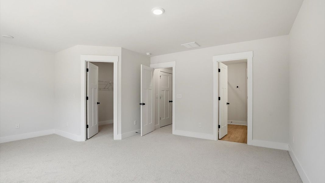 Eye-catching details and elegant finishes in the vibrant primary suite of this select home at the new Marion Square community